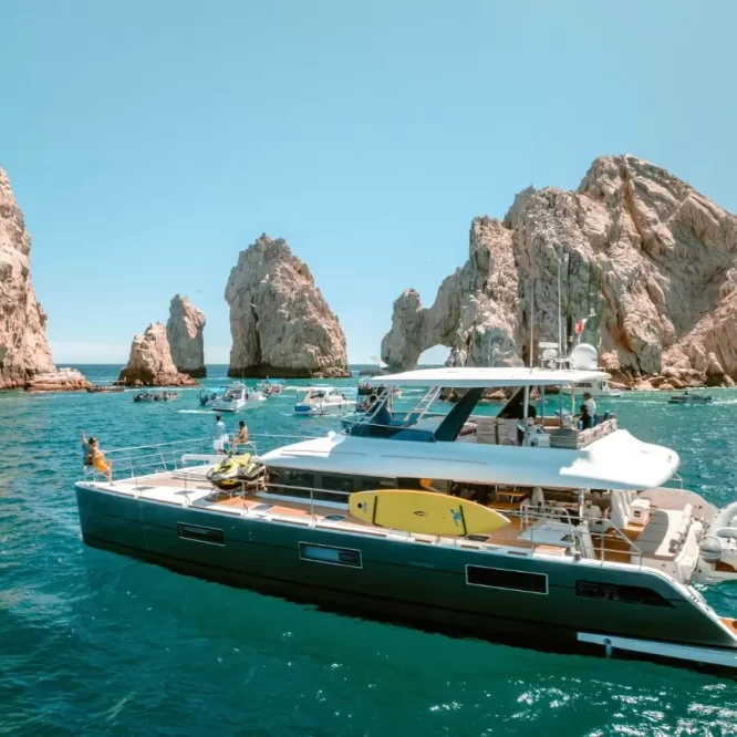 Drone photo of Lagoon 630 Power Catamaran sailing across Cabo San Lucas Luxury Yacht Rental Cabo San Lucas Ozean Luxe Charters