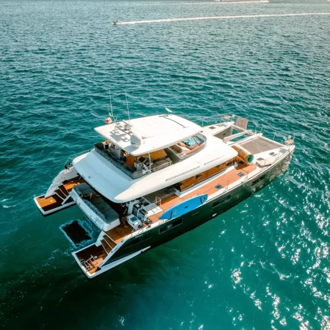 Drone photo of Lagoon 630 Power Catamaran sailing across Cabo San Lucas Luxury Yacht Rental Cabo San Lucas Ozean Luxe Charters