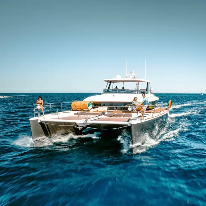 Drone photo of Lagoon 630 Power Catamaran sailing across Cabo San Lucas Luxury Yacht Rental Cabo San Lucas Ozean Luxe Charters