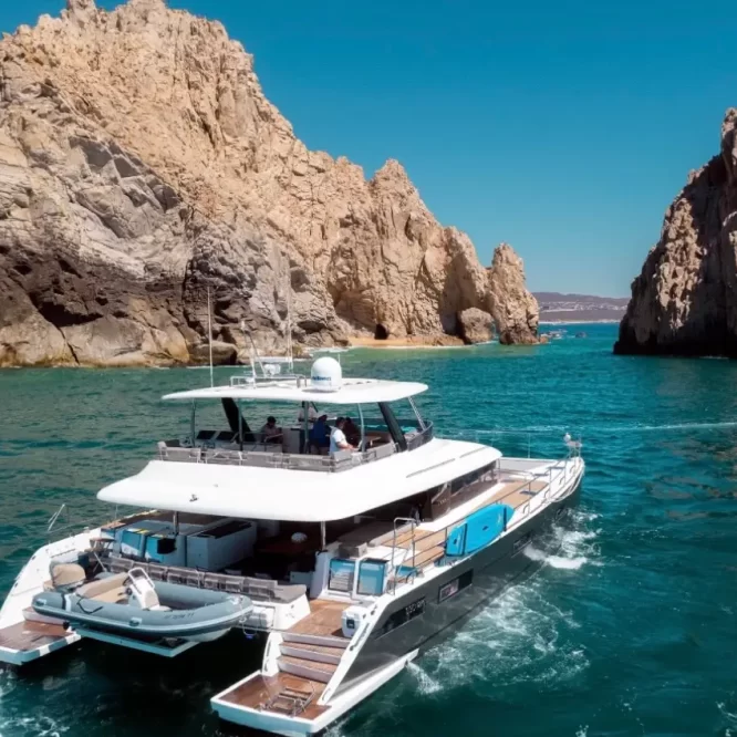 Drone photo of Lagoon 630 Power Catamaran sailing across Cabo San Lucas Luxury Yacht Rental Cabo San Lucas Ozean Luxe Charters