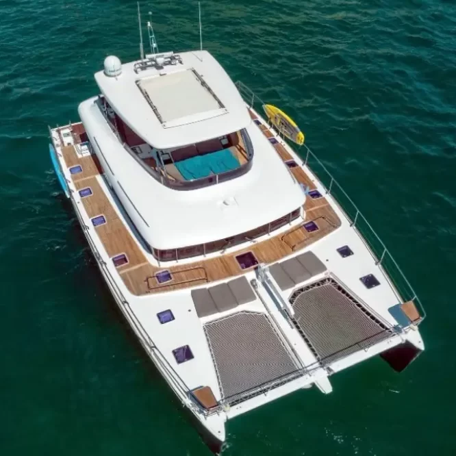 Drone photo of Lagoon 630 Power Catamaran sailing across Cabo San Lucas Luxury Yacht Rental Cabo San Lucas Ozean Luxe Charters